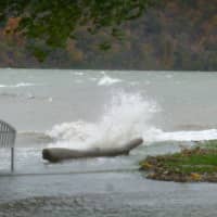 <p>Waves break over the banks of the Hudson River in Hastings Monday morning.</p>