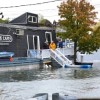 <p>Flood waters reach the Black Duck Cafe on Riverside Avenue Monday following one of three expected high tide cycles.</p>