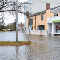 <p>Flood waters from the Saugatuck River flow into Parker Harding Plaza Monday afternoon.</p>