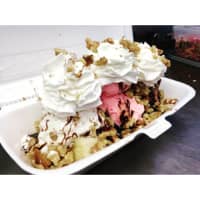 <p>Banana split with chocolate vanilla and strawberry topped with hot fudge walnuts and whipped cream at Scoops N&#x27;More in Carmel.</p>