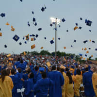 <p>Newly minted Mahopac High School graduates throw their mortarboards in the air to celebrate.</p>