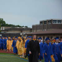 <p>Mahopac officials and class of 2015 members walk to commencement.</p>