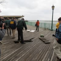 <p>A Westchester County Parks official standing above a missing section of boardwalk at Playland Park in Rye. </p>