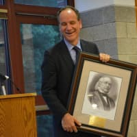 <p>Andrew Selesnick, an outgoing assistant superintendent who is taking the top administrative post in Katonah-Lewisboro, is given a large image of Horace Greeley.</p>