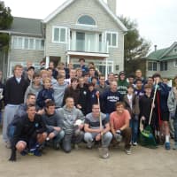 <p>Members of the Staples High School freshman, junior varsity and varsity soccer teams got together Wednesday to clear tons of sand that was dumped on the front yard of teammate Sebo Hood&#x27;s home during Hurricane Sandy.</p>
