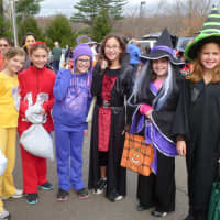 <p>These girls, dressed as Teletubbies and witches, racked up on candy during Wilton&#x27;s Trunk or Treat at Cider Mill School.</p>
