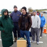 <p>Nathaniel Fasman (right) stands in  line with his mother, Barbara, to get dry ice Wednesday at Empire City Casino in Yonkers.</p>