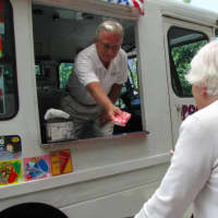 <p>River House member, Anne, is handed a strawberry ice cream bar</p>