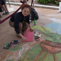 <p>Therese Schorn, of Ossining, works on her chalk art work Saturday at the Sidewalk Chalk Art Festival.</p>