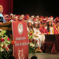 <p>Harrison Superintendent Louis N. Wool speaking to 246 high school graduates, family and friends Friday night during commencement at SUNY Purchase Performing Arts Center.</p>