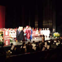 <p>Muhammad Ahmed, a volunteer firefighter in Harrison, receives his high school diploma on Friday night. He&#x27;s the oldest of four Ahmed children.</p>