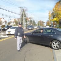 <p>A auxilliary officer guides drivers who waited on line for gas in Dobbs Ferry.</p>