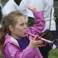 <p>A little girl blows her horn while watching the Great Street Parade.</p>