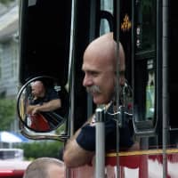 <p>A first responder pops his head out of his truck to say hello to spectators at Sunday&#x27;s Great Street Parade.</p>