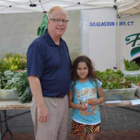 <p>Mayor Mark Boughton poses with a young shopper at the Danbury Farmers Market. </p>