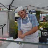 <p>Alessandro Dipierro from Brewster Pastry bags up some goodies at the Danbury Farmers Market. </p>