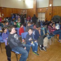 <p>Dobbs Ferry children watch a movie screened by the Recreation Department and Police Benevolent Association Thursday at the Embassy Community Center.</p>