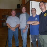 <p>Dobbs Ferry Recreation Supervisor Matt Arone, second from left, staffer Mike Dominici, second from right, and Police Officer Justin Kamke, right, provided a movie and refreshments.</p>