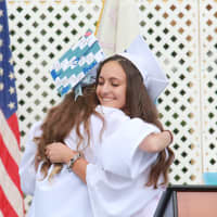 <p>Westlake HIgh School senior Lexi Pichiarallo hugs Class of 2015 President Samantha Howard at Friday&#x27;s commencement exercises.</p>