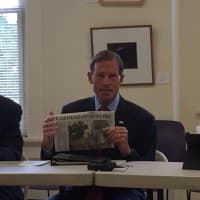 <p>U.S. Sen. Richard Blumenthal (D-Conn.) holds up a newspaper referencing the shooting at a city housing complex this month during a roundtable Monday morning in Bridgeport with Mayor Bill Finch.</p>