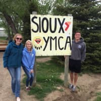 <p>Jessica Krueger, Liz Morrissey and Jake Greene, all from Darien, arrive at the Sioux YMCA.</p>