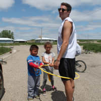 <p>Jake Greene gets put in jail while playing with children in the in Swiftbird community at the reservation.</p>
