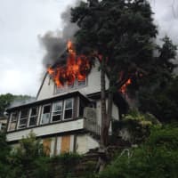 <p>A three-alarm fire that ripped through a two-and-a-half story home at 2 Landscape Place in Yonkers on Monday is under control.</p>