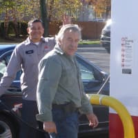 <p>Jean-Louis LeBritain, owner of the Citgo station on East Putnam Avenue in Greenwich, right, and one of his employees help customers pump gas into cars and gas canisters.</p>