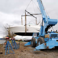 <p>Boats that washed from their moorings at the Croton Yacht Club are retrieved by a crane. </p>