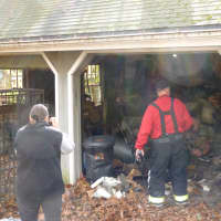 <p>Maxine McAvity, left, and Rowayton Fire Chief Ed Carlson survey the damage from a garage fire Friday at McAvity&#x27;s home on Little Brook Road in Rowayton.</p>