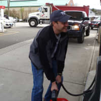 <p>Stephen Jones of Pimpewaug Road in Wilton is taking the loss of power from Hurricane Sandy as best he can. He&#x27;s pictured here at the Wheels Convenience gas station to get gas for his home&#x27;s generator.  </p>