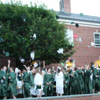 <p>Members of the Class of 2015 toss their mortarboards in celebration. </p>