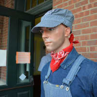 <p>A lifelike mannequin, dressed in railroad worker attire, is displayed in front of the Bedford Hills exhibit.</p>