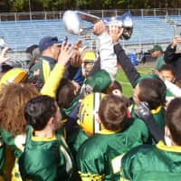 <p>Players on the Norwalk Packers celebrate after Saturday&#x27;s victory over Bridgeport.</p>