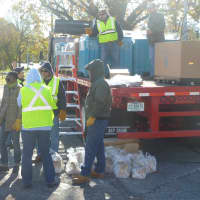 <p>Several Con Edison workers were on hand Saturday at the Westchester County Center to distribute dry ice to residents still in the dark after Hurricane Sandy.</p>