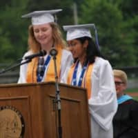 <p>Valedictorian Emma Manos and Salutatorian Sonya Chandy address their classmates at the graduation ceremony.</p>
