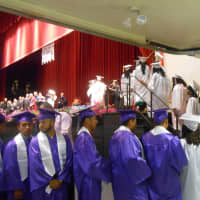 <p>Lincoln High School students line up to walk on the stage and receive their diplomas.</p>
