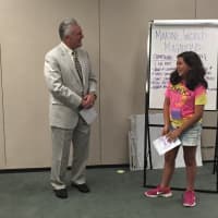 <p>Students read thank-you notes to  Rilling and Task Force Chair John Kydes.</p>