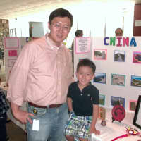 <p>Four-year-old Lucas Zhu of Harrison and his father, Yu Zhu show off a
display Lucas made for his Pre-K graduation at the
Country Children&#x27;s Center in Yorktown.</p>