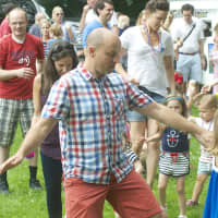 <p>A dad leads a dance line at Darien&#x27;s Fourth of July celebration at Tilley Pond Park.</p>