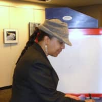 <p>Gail Bolling fills out her ballot at the Greenburgh Public Library on Tuesday.</p>
