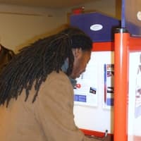 <p>Shiek Browne fills out his ballot at the Greenburgh Public Library on Tuesday.</p>