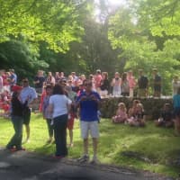 <p>Residents of Nod Hill Road in Wilton line the street and the stone walls for the homegrown parade </p>