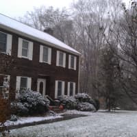 <p>A thin layer of snow blankets the front lawn of this Westport home early Wednesday afternoon.</p>
