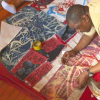 <p>A member of the Harlem Needle Arts association working on the piece and the other is the finished piece. </p>