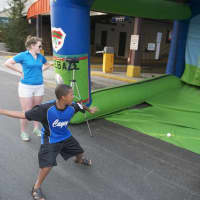 <p>A boy finds out how fast he can throw at the speed gun booth.</p>