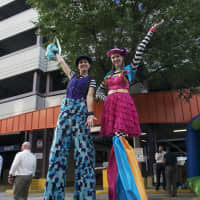 <p>Two girls on stilts greet visitors at Tuesday&#x27;s block party.</p>