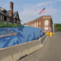 <p>A painting of rowers on the Saugatuck River brighten the construction site fence in downtown Westport. </p>