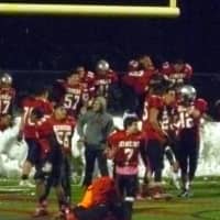 <p>Some of the Somers football players jump into the piles of snow near the end zone to celebrate the win.</p>