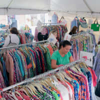 <p>Shoppers stroll through a clothing display along the Post Road.</p>
